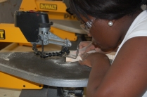 Dwaynasia Webb operates the scroll saw for a project she is building.
